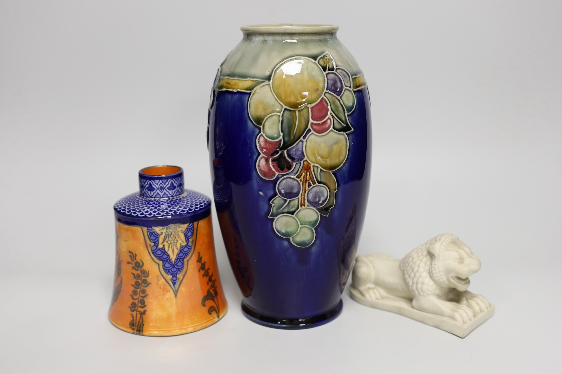 A Copeland Parian figure of an Assyrian lion, a Doulton tube lined vase and Doulton lustre pot, vase 25cms high